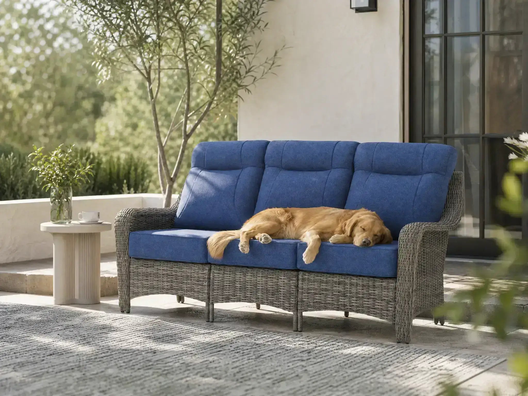 OuterCraft 3-seater outdoor wicker patio sofa featuring high-back ergonomic lumbar support and scratch-resistant Blue Olefin cushions in sunlit patio