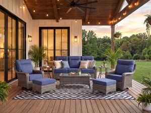 OuterCraft 8-piece all-weather wicker patio furniture set with blue cushions on a covered sunset porch deck.