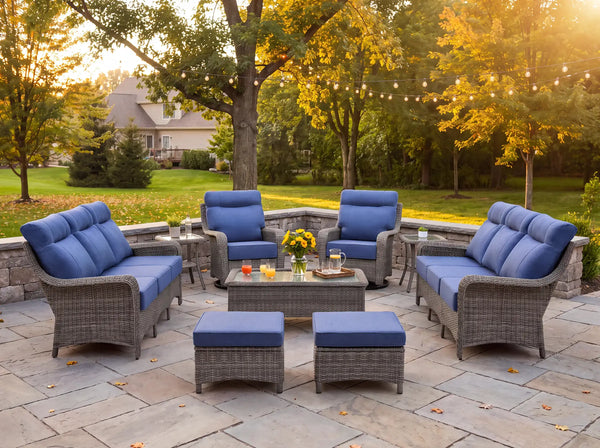 OuterCraft 9-piece dark PE rattan patio set with blue cushions styled in a luxury estate backyard setting.