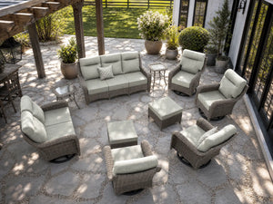 OuterCraft 10-piece dark PE rattan patio set with 3-seater sofa, loveseat, 360-degree swivel rocker chairs, ottomans and side tables with 6-inch thick light gray cushions styled on a grand estate patio