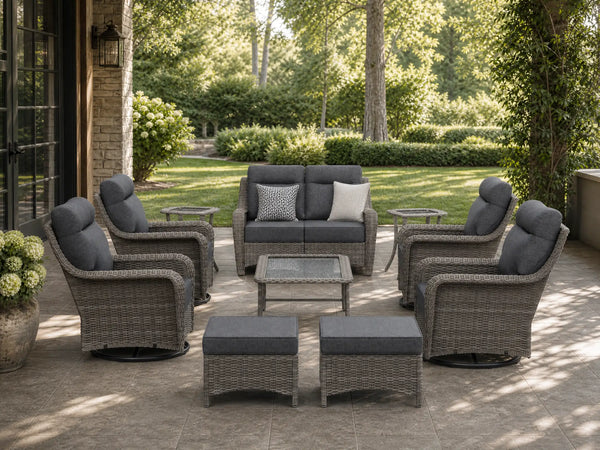 OuterCraft 10-piece dark PE rattan patio set with loveseat, 360-degree swivel rocker chairs, ottomans, side table and coffee table set with 6-inch thick dark gray cushions styled on a grand estate patio