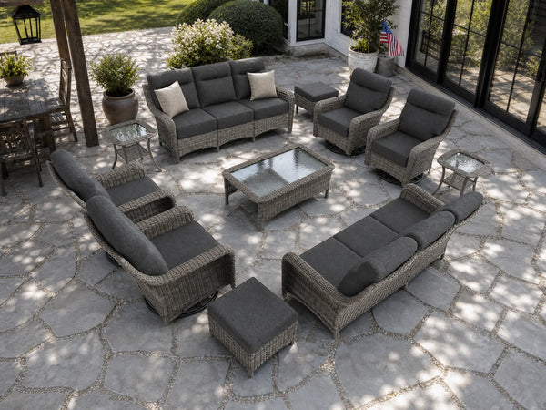 OuterCraft 11-piece dark PE rattan patio set with 3-seater sofas, 360-degree swivel rocker chairs, ottomans, coffee table and side tables with 6-inch thick dark gray cushions styled on a grand estate patio