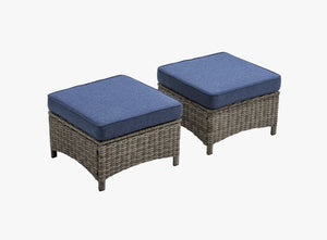 OuterCraft dark PE rattan hand-woven ottomans with thick blue cushions on clean white background