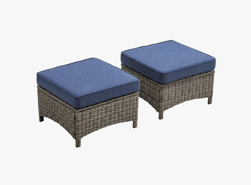 OuterCraft dark PE rattan hand-woven ottomans with thick blue cushions on clean white background