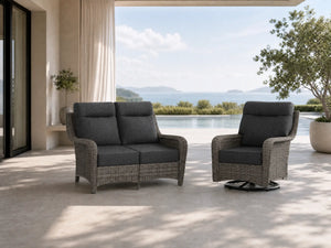 OuterCraft dark PE rattan loveseat and 360-degree swivel rocker chairs with 6-inch thick dark gray cushions styled on a grand estate patio
