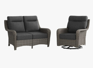 OuterCraft dark PE rattan loveseat and 360-degree swivel rocker chairs with 6-inch thick dark gray cushions on clean white background
