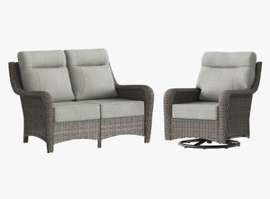 OuterCraft dark PE rattan loveseat and 360-degree swivel rocker chairs with 6-inch thick light gray cushions on clean white background