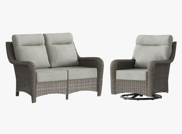 OuterCraft dark PE rattan loveseat and 360-degree swivel rocker chairs with 6-inch thick light gray cushions on clean white background