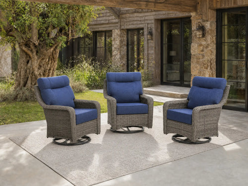 OuterCraft 3-piece dark PE rattan 360-degree swivel rocker chairs and 6-inch thick blue cushions styled on a grand estate patio