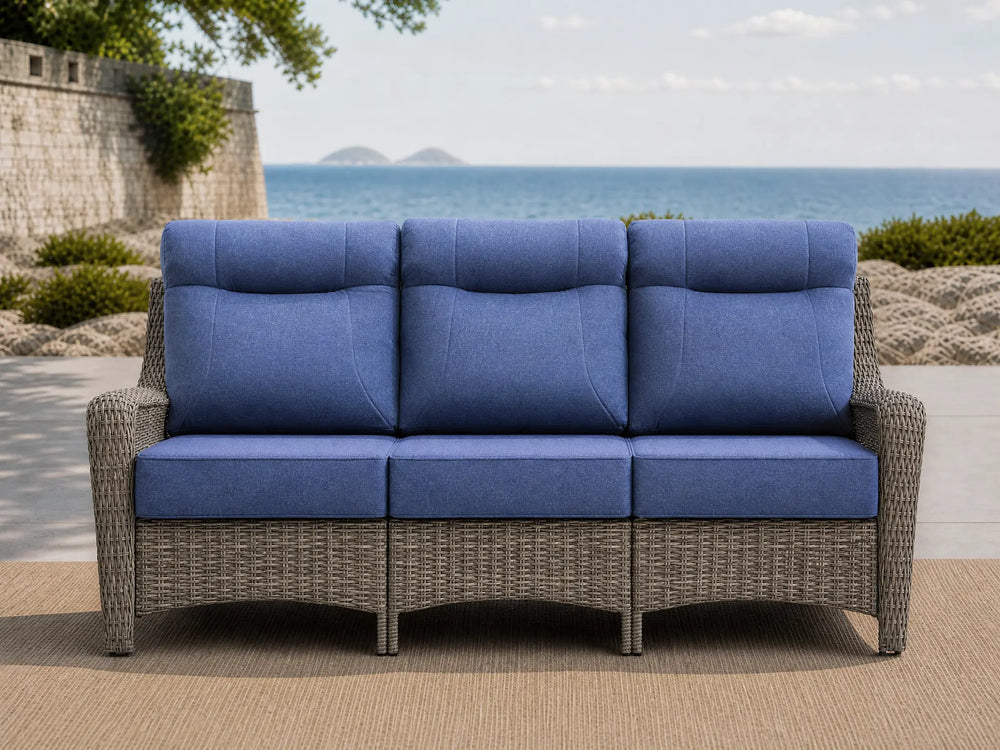 OuterCraft 3-seater all-weather dark PE wicker sofa with 6-inch thick light gray cushions on a grand estate patio