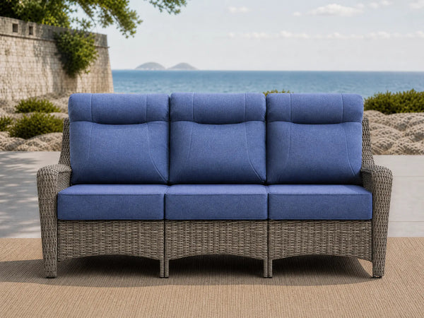 OuterCraft 3-seater all-weather dark PE wicker sofa with 6-inch thick blue cushions on a grand estate patio
