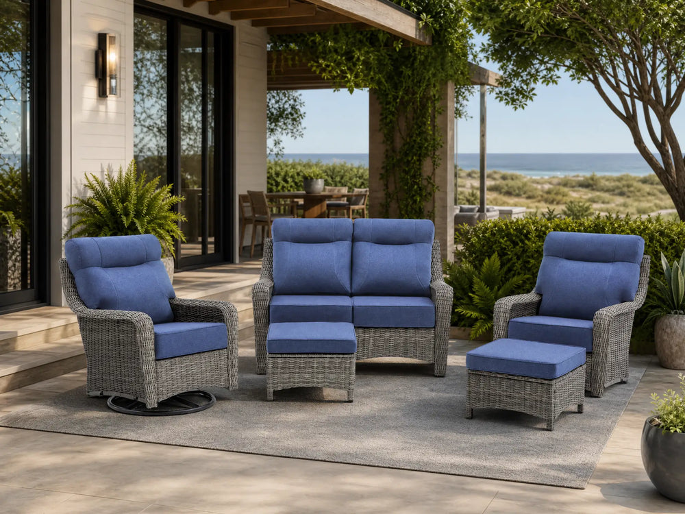 OuterCraft 5-piece dark PE rattan patio set with loveseat, 360-degree swivel rocker chairs and ottomans set with 6-inch thick blue cushions styled on a grand estate patio