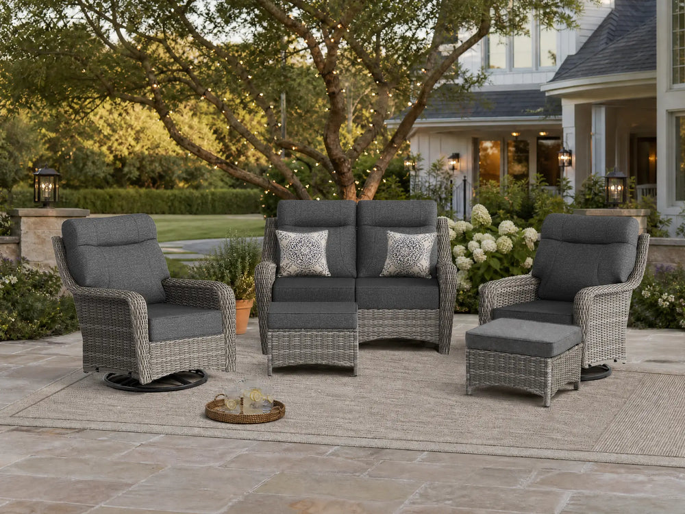 OuterCraft 5-piece dark PE rattan patio set with loveseat, 360-degree swivel rocker chairs and ottomans set with 6-inch thick blue cushions styled on a grand estate patio