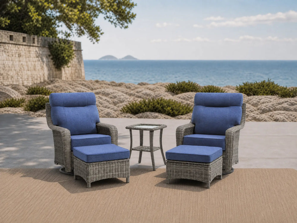 OuterCraft 5-piece dark PE rattan 360-degree swivel rocker chairs, ottomans and side table set with 6-inch thick dark gray  cushions styled on a grand estate patio