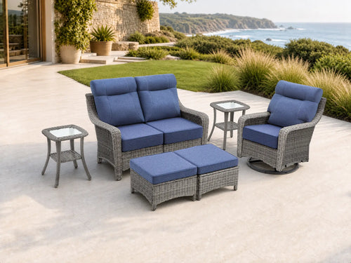OuterCraft 6-piece dark PE rattan patio set with loveseat, 360-degree swivel rocker chairs, ottomans and side table set with 6-inch thick blue cushions styled on a grand estate patio
