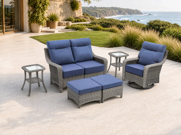 OuterCraft 6-piece dark PE rattan patio set with loveseat, 360-degree swivel rocker chairs, ottomans and side table set with 6-inch thick blue cushions styled on a grand estate patio