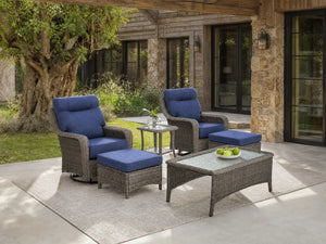 OuterCraft 6-piece dark PE rattan 360-degree swivel rocker chairs, ottomans, coffee table and side table set with 6-inch thick blue cushions styled on a grand estate patio