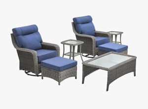 OuterCraft 7-piece dark PE rattan 360-degree swivel rocker chairs, ottomans, coffee table and side table set with 6-inch thick blue cushions on clean white background