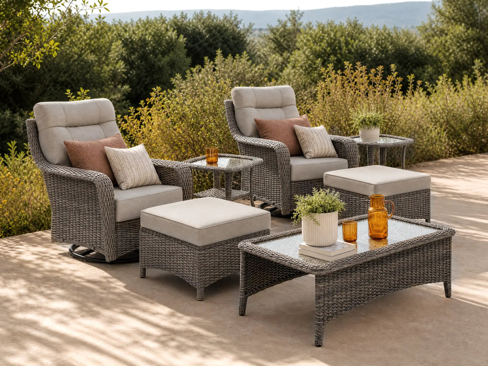 OuterCraft 7-piece dark PE rattan 360-degree swivel rocker chairs, ottomans, coffee table and side table set with 6-inch thick blue cushions on a grand estate patio
