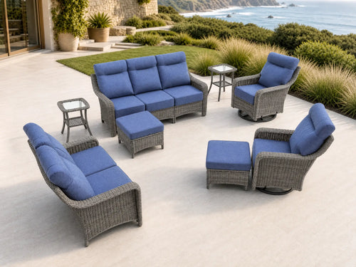 OuterCraft 8-piece dark PE rattan patio set with 3-seater sofa, loveseat with 360-degree swivel rocker chairs, ottomans and side tables set with 6-inch thick blue cushions styled on a grand estate patio