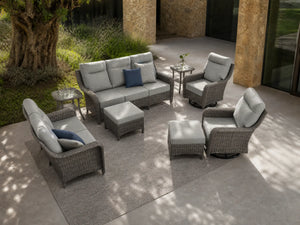 OuterCraft 8-piece dark PE rattan patio set with 3-seater sofa, loveseat with 360-degree swivel rocker chairs, ottomans and side tables set with 6-inch thick light gray cushions styled on a grand estate patio