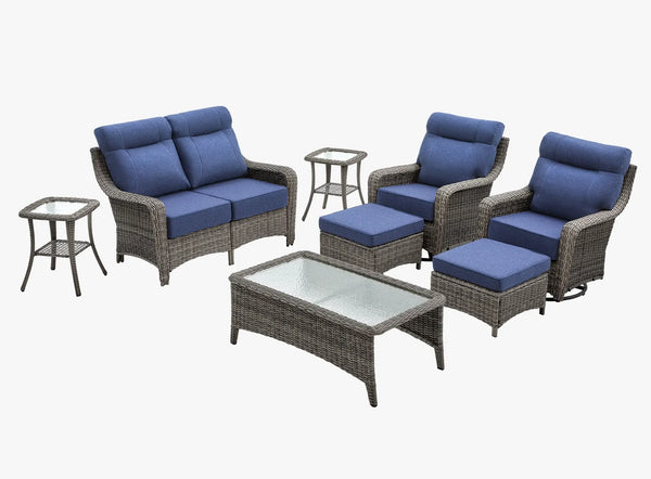 OuterCraft 8-piece dark PE rattan patio set with loveseat, 360-degree swivel rocker chairs, ottomans, coffee table and side table set with 6-inch thick blue cushions on clean white background