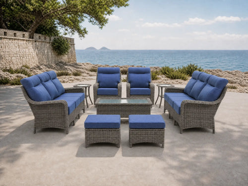 OuterCraft 9-piece dark PE rattan patio set with 3-seater sofas, 360-degree swivel rocker chairs, ottomans, coffee table and side tables with 6-inch thick blue cushions styled on a grand estate patio