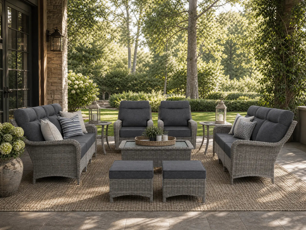 OuterCraft 9-piece dark PE rattan patio set with 3-seater sofas, 360-degree swivel rocker chairs, ottomans, coffee table and side tables with 6-inch thick light gray cushions styled on a grand estate patio