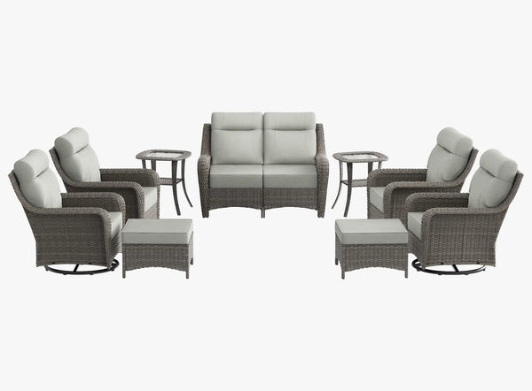OuterCraft 9-piece dark PE rattan patio set with loveseat, 360-degree swivel rocker chairs, ottomans and side table set with 6-inch thick light gray cushions on clean white background