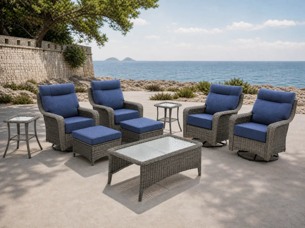 OuterCraft 9-piece dark PE rattan patio set with 360-degree swivel rocker chairs, ottomans, coffee table and side table set with 6-inch thick blue cushions styled on a grand estate patio