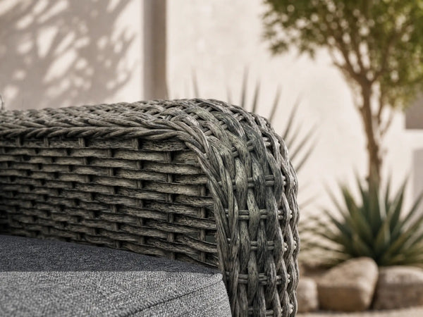 Close-up of OuterCraft dark gray hand-woven all-weather PE wicker armrest texture and weather-resistant cushion fabric