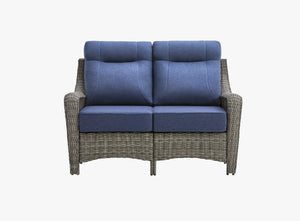 OuterCraft all-weather dark PE rattan loveseat and 6-inch thick blue cushions on clean white background