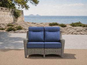OuterCraft all-weather dark PE rattan loveseat and 6-inch thick blue cushions styled on a grand estate patio