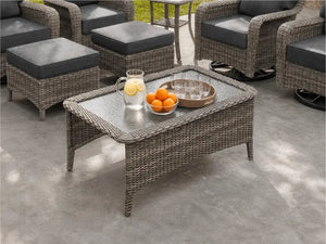 Close-up of OuterCraft dark PE wicker rectangle outdoor coffee table showing tempered glass top and hand-woven border detail