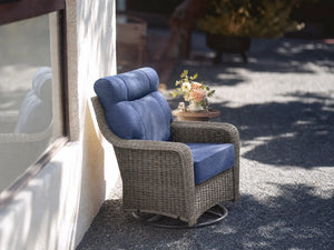 OuterCraft dark PE rattan 360-degree swivel rocker chairs and 6-inch thick blue cushions styled on a grand estate patio