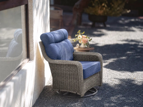 OuterCraft dark PE rattan 360-degree swivel rocker chairs and 6-inch thick blue cushions styled on a grand estate patio