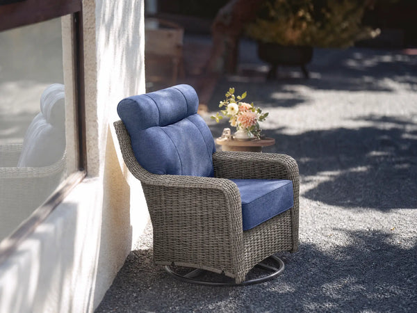 OuterCraft dark PE rattan 360-degree swivel rocker chairs and 6-inch thick blue cushions styled on a grand estate patio