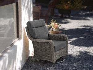OuterCraft dark PE rattan 360-degree swivel rocker chairs and 6-inch thick dark gray cushions styled on a grand estate patio