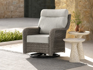 OuterCraft dark PE rattan 360-degree swivel rocker chairs and 6-inch thick light gray cushions styled on a grand estate patio