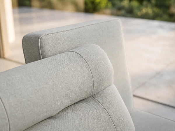 Macro detail of OuterCraft ergonomic outdoor sofa backrest featuring integrated cervical support cushion in weather-resistant light gray Olefin