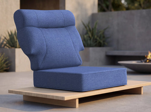 Close-up of OuterCraft ergonomic high-back outdoor cushion set in navy blue weather-resistant Olefin fabric on minimalist wooden platform