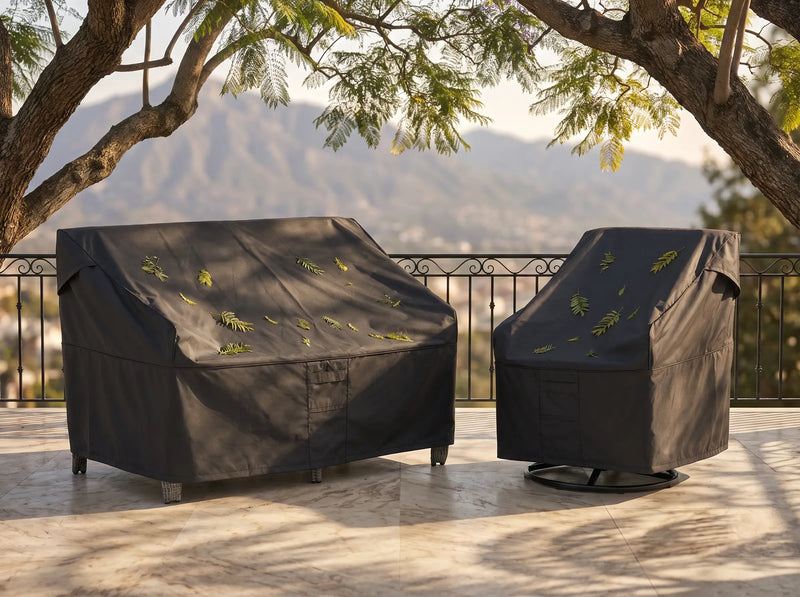 OuterCraft heavy-duty waterproof outdoor furniture covers protecting patio sofa and swivel chair on a scenic terrace. 