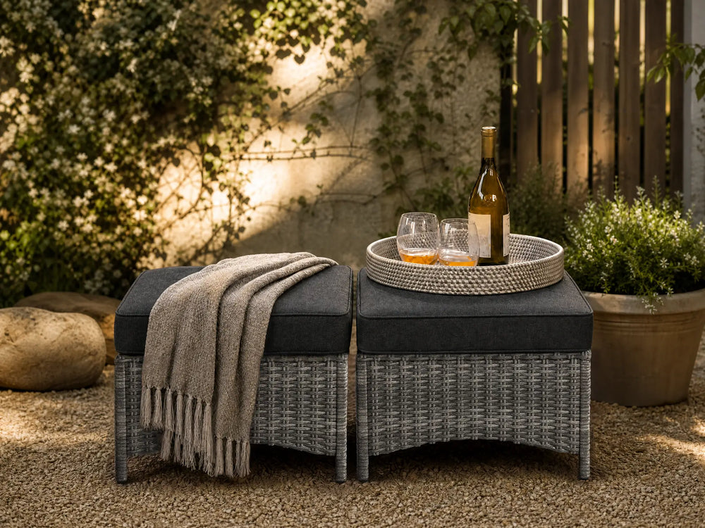 OuterCraft modular outdoor wicker ottomans featuring high-density dark core cushions, seamlessly arranged with lifestyle decor to showcase versatile seating and zero-sag resilience.