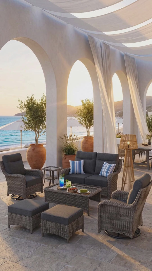 OuterCraft luxury 9-piece all-weather wicker patio furniture set with swivel rockers and coffee table styled in a sunlit Mediterranean villa terrace.